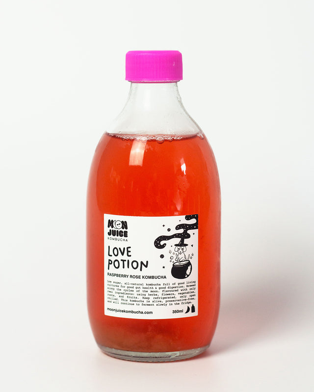 A 350ml bottle of Love Potion (Raspberry Rose Kombucha) with a pink cap against a clean white background.