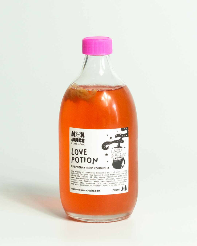 A 500ML bottle of Love Potion (Raspberry Rose Kombucha) with a pink cap against a clean white background.