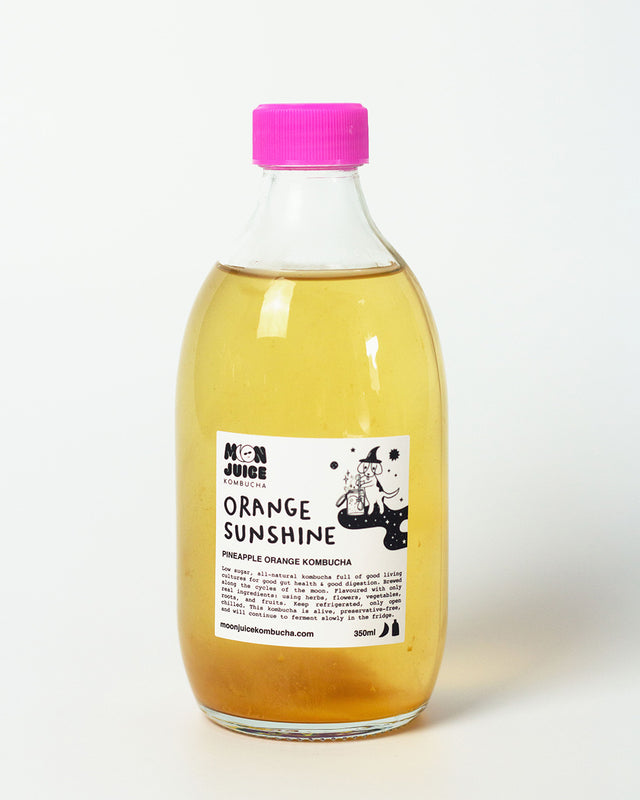 A 350ml bottle of Orange Sunshine (Pineapple Orange Kombucha) with a pink cap against a clean white background.