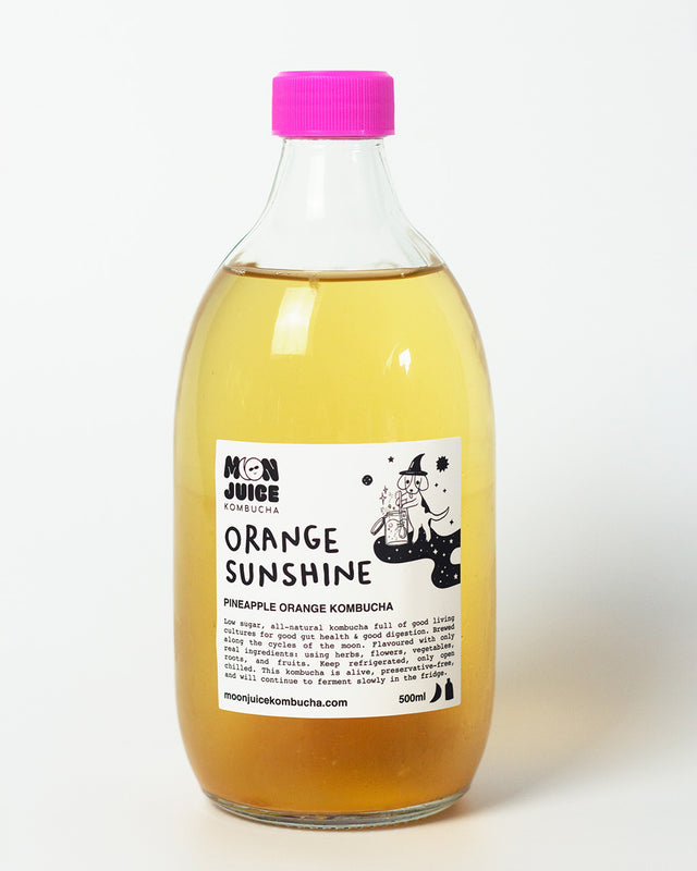 A 500ml bottle of Orange Sunshine (Pineapple Orange Kombucha) with a pink cap against a clean white background.