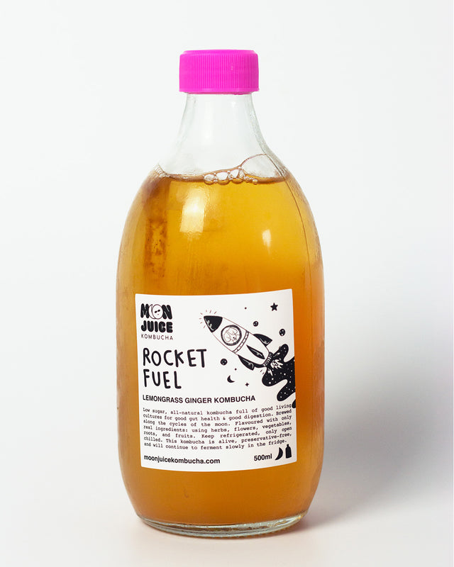 A 500ML bottle of Rocket Fuel (Lemongrass Ginger Kombucha) with a pink cap against a clean white background.