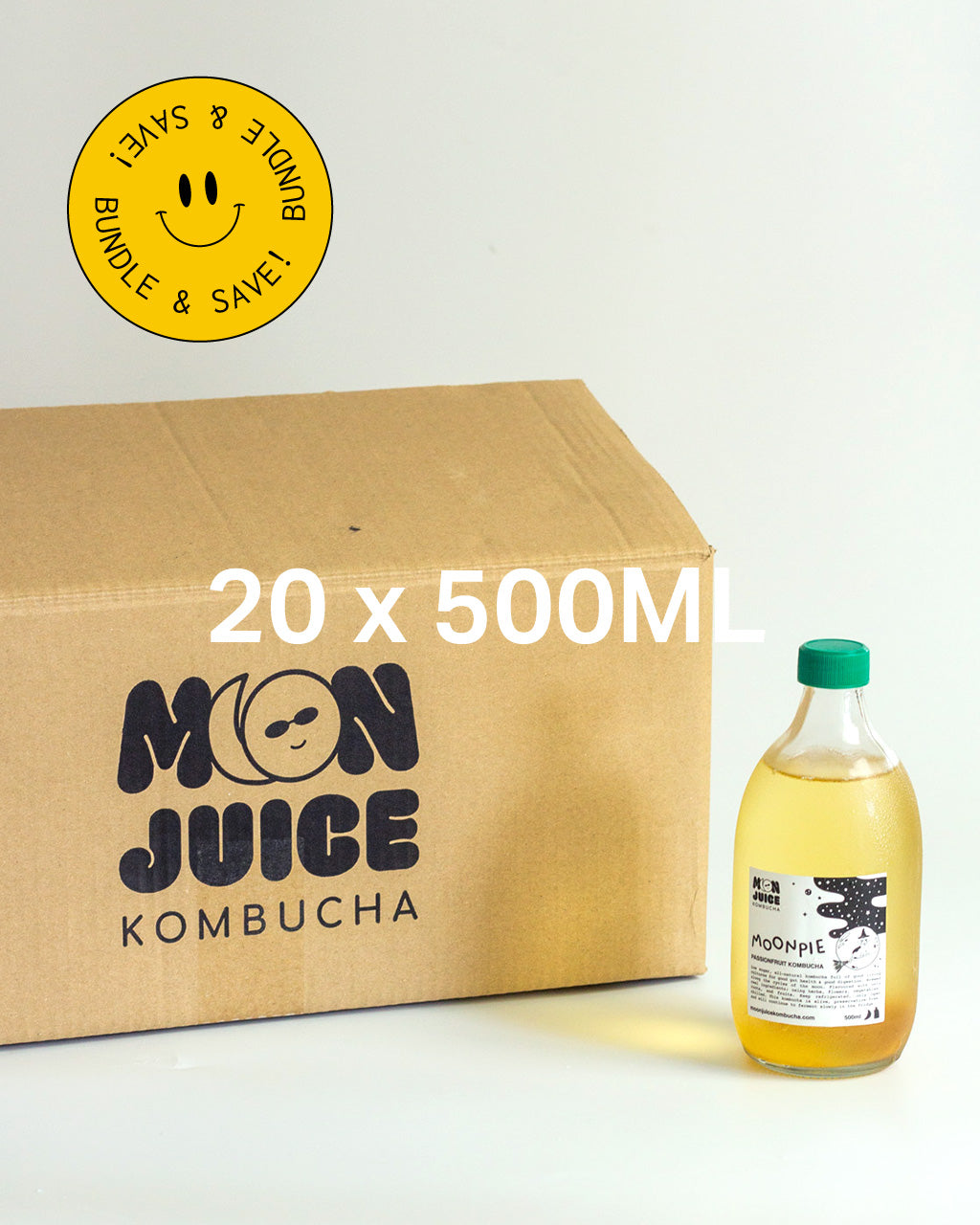A 500ML bottle of Moonpie kombucha next to a carton with "Moon Juice Kombucha" branding on a light background, with the caption "8 x 500ML" and a yellow sticker with the words "Bundle & Save" 