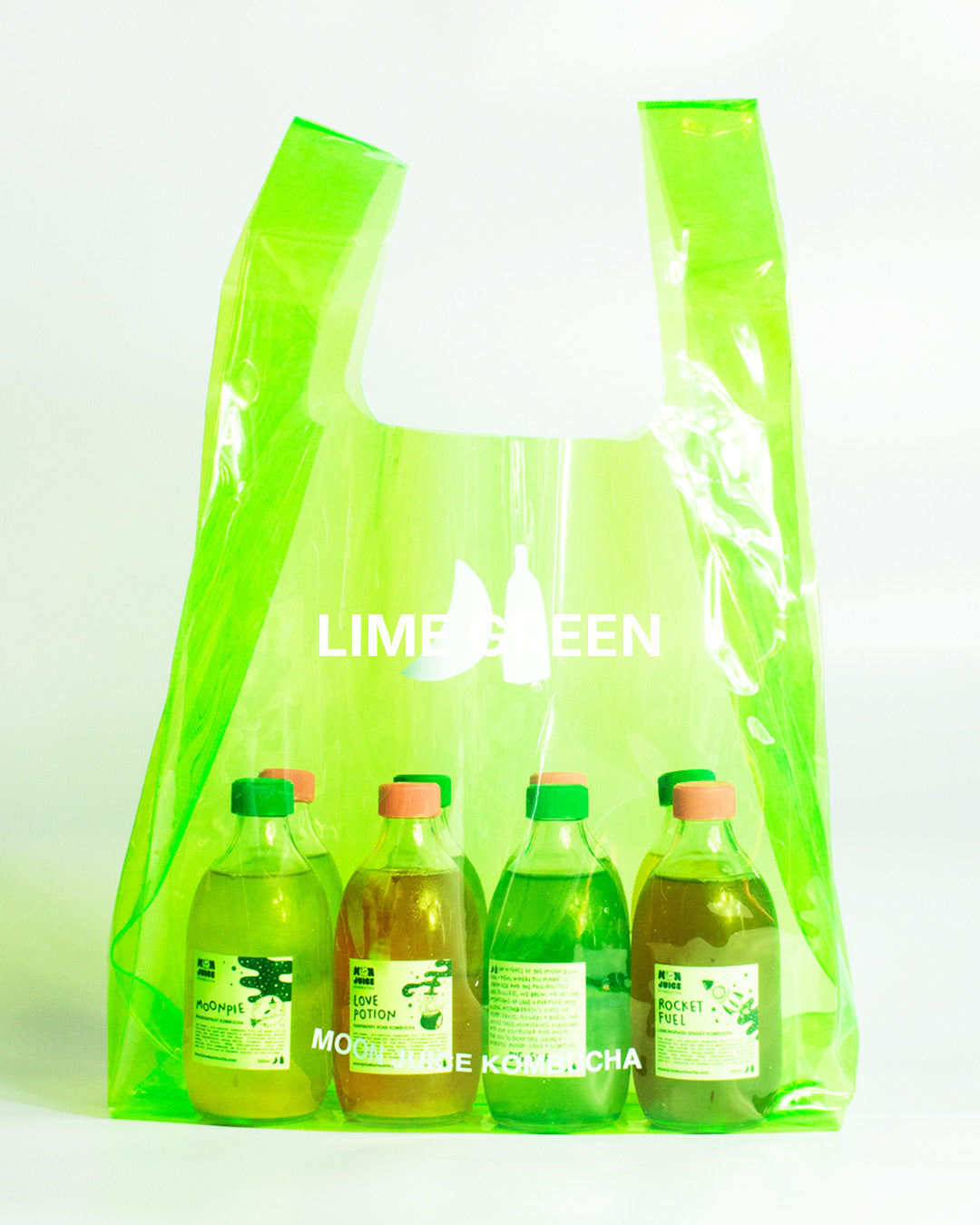 A translucent lime green jellybag with printed 'MOON JUICE KOMBUCHA' text, shown against a plain white background. The bag contains 8 kombucha bottles.