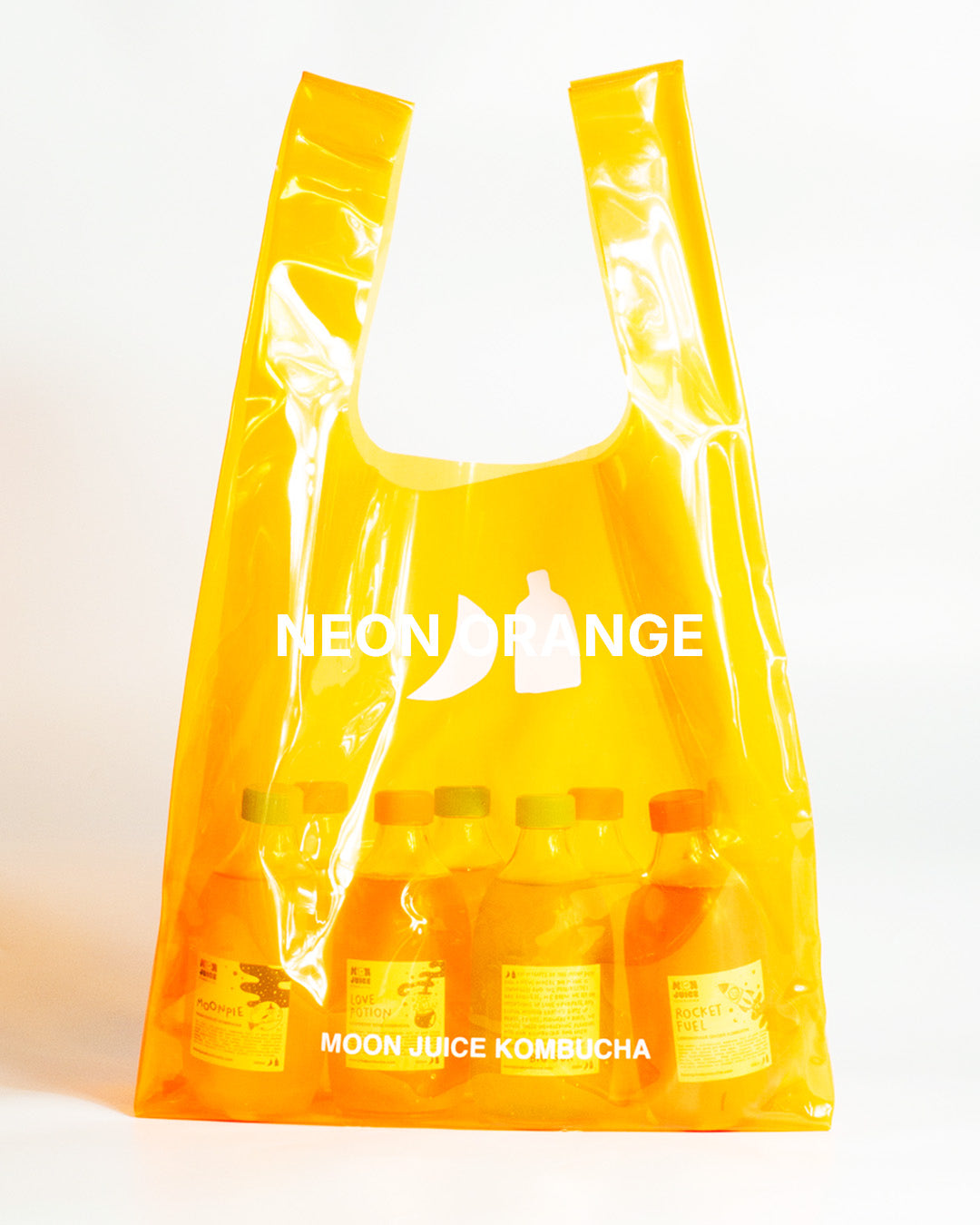 A translucent neon orange jellybag with printed 'MOON JUICE KOMBUCHA' text, shown against a plain white background. The bag contains 8 kombucha bottles.