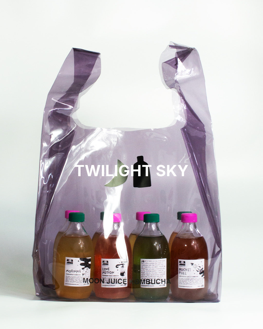 A translucent dark purple jellybag with printed 'MOON JUICE KOMBUCHA' text, shown against a plain white background. The bag contains 8 kombucha bottles.