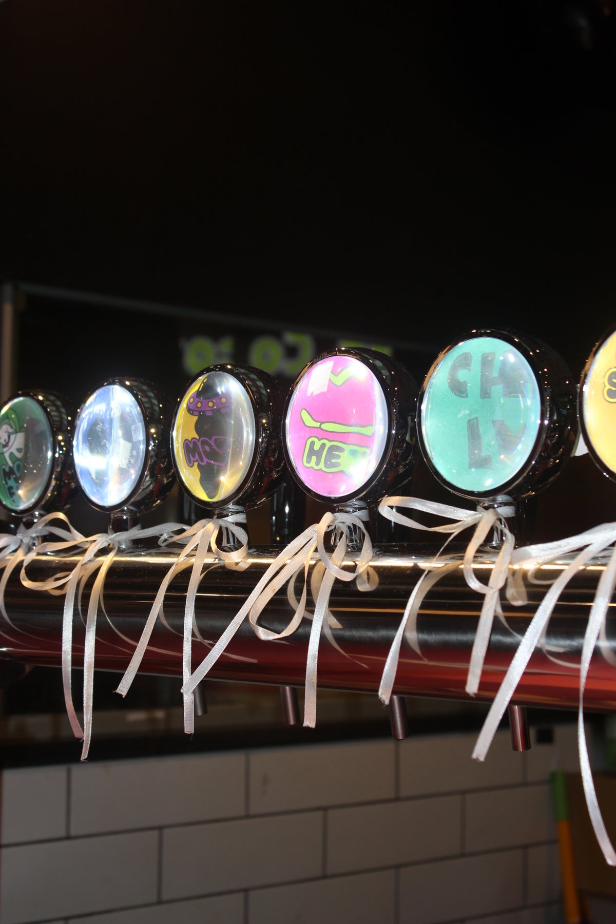 A close up shot of our kombucha tap tower with 5 flavour labels  visible