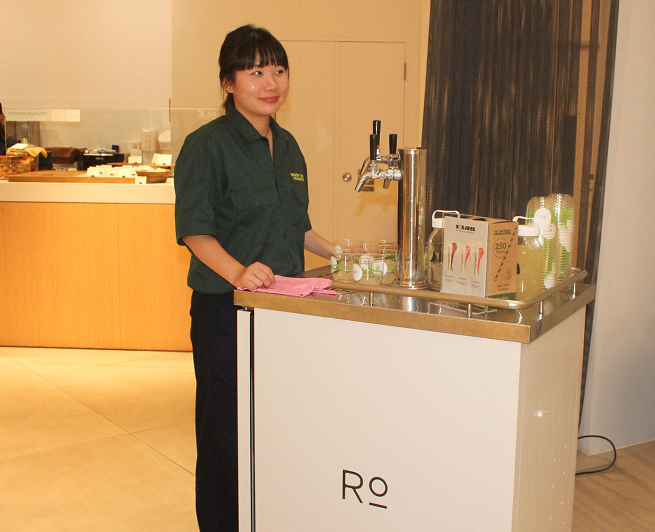 Our kombucha cart set up at Romi's store event, featuring a custom branded cart.