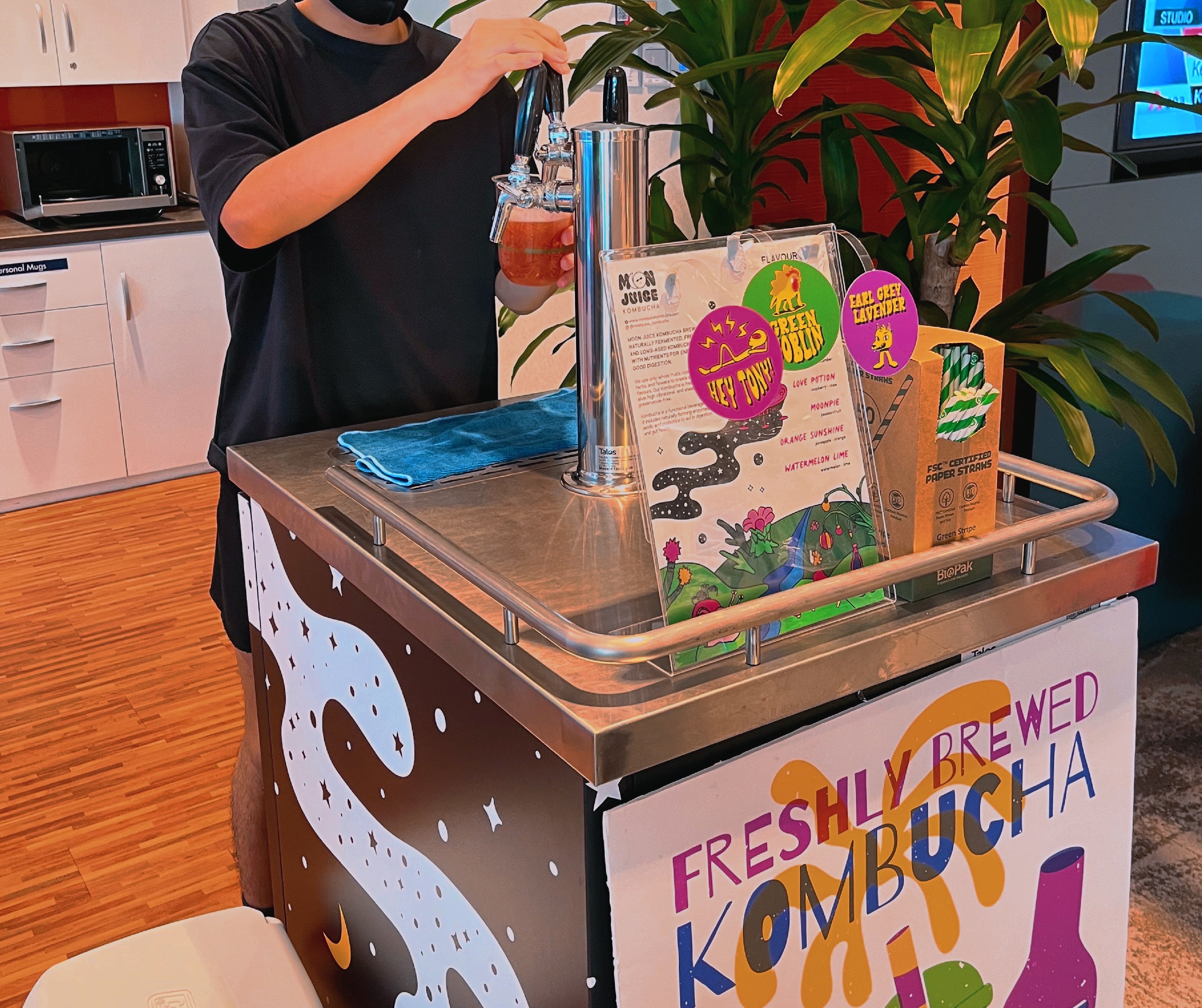 An image of Moon Juice Kombucha's pop up station at an office including a kegerator