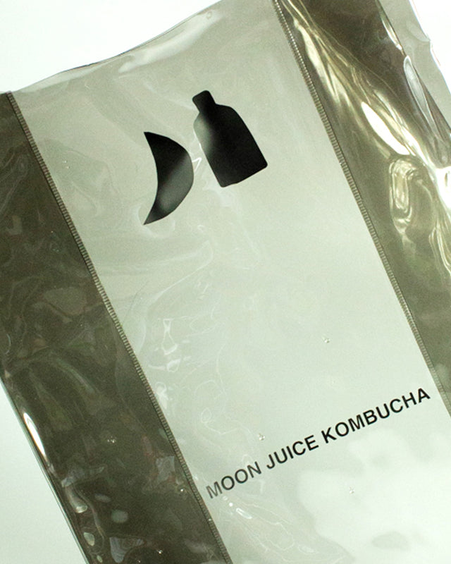 Dark Gray Moon Juice Kombucha jellybag with a black logo and text, photographed close up against a light background.