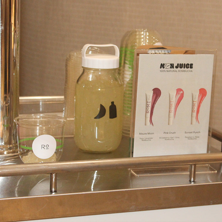 An A5 menu with 3 lip gloss swatches as flavours on it, next to a jar of bubble toppings.