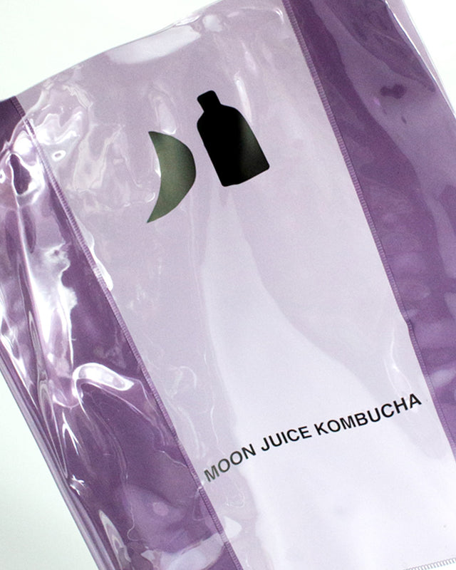Dark purple Moon Juice Kombucha jellybag with a black logo and text, photographed close up against a light background.
